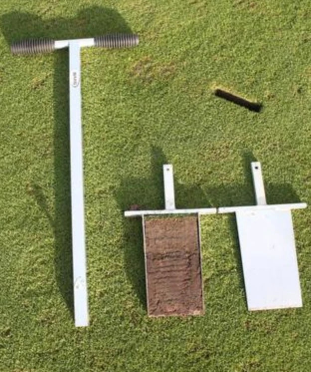BMS Soil Profile Sampler laid on a golf green beside a removed soil profile sample