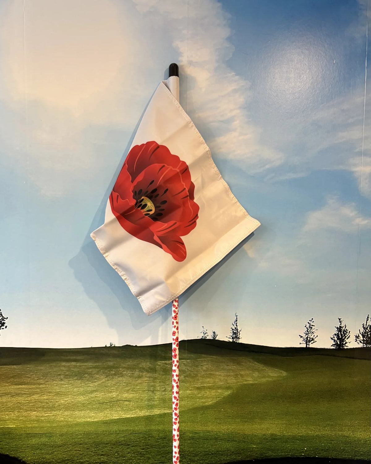 Remembrance golf flag: white tube lock flag with a large red poppy, on a poppy-print flagstick