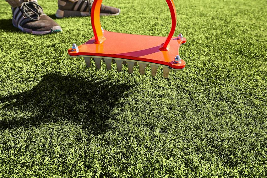 Close up of the Accuform Slot Seeder slotting blades on turf