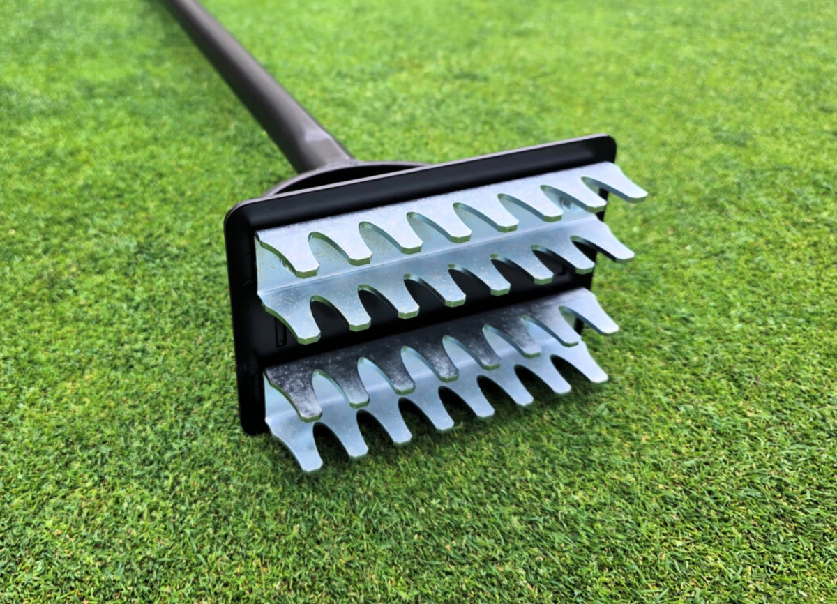 Close up of the slotter blades on the BMS Static Seed Slotter on a golf green