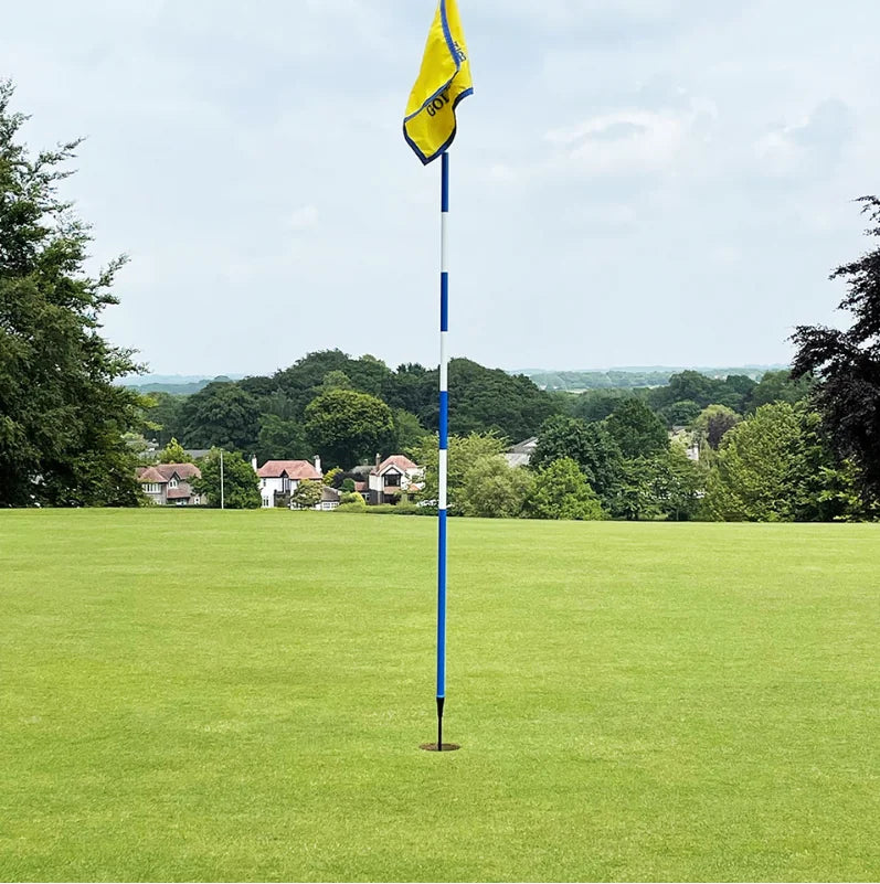 Slim Pin with a yellow flag and blue and white striped shaft standing in the hole on a green